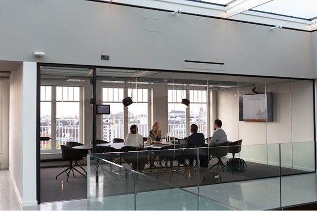Business team meeting in a glass-walled conference room